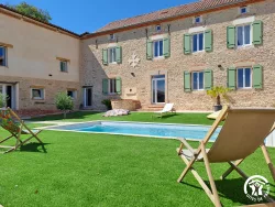 Piscine devant la façade en pierre au Domaine des Hirondelles